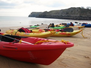 Beach cleaning by kayak, NT Stackpole, Wales. Copyright Gretta Schifano.