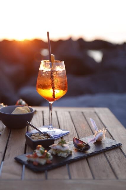Italian aperitif at the sunset by the sea - The Setting and Atmosphere