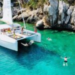 Porto Conte: Half-day catamaran tour with aperitif - Sailing to Capo Caccia