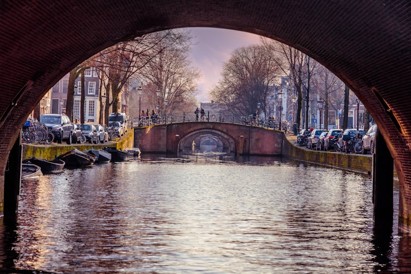 Amsterdam canal through bridge arch