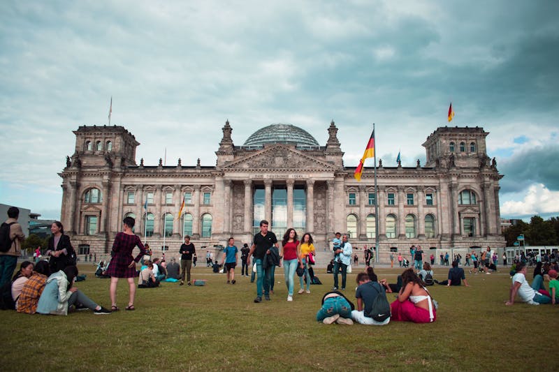 Tourists on lawn in front of Reichstag Building Berlin