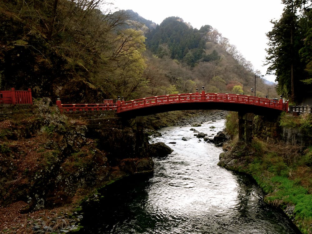 Red Shinkyo Bridge over river in Nikko Japan