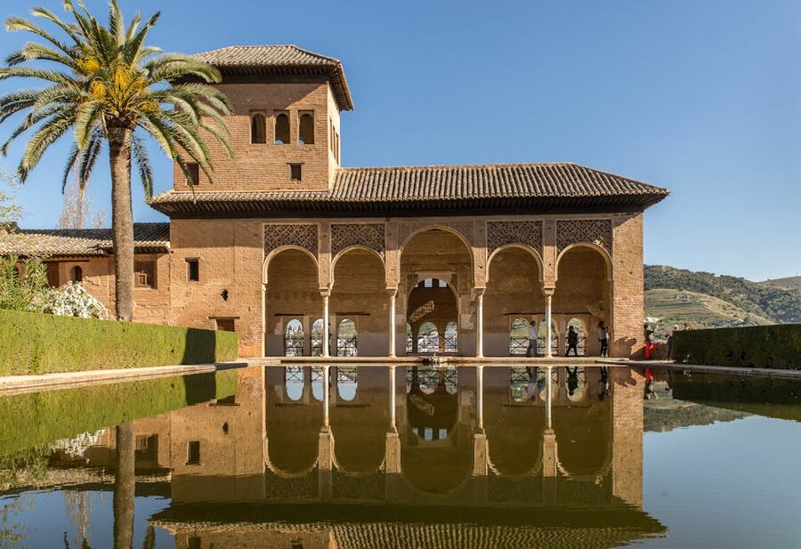 Alhambra arches reflected in water