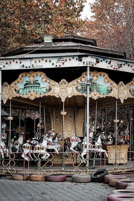 Colourful carousel with painted horses at amusement park