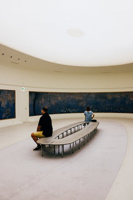 Visitor sitting on bench looking at large painting in gallery
