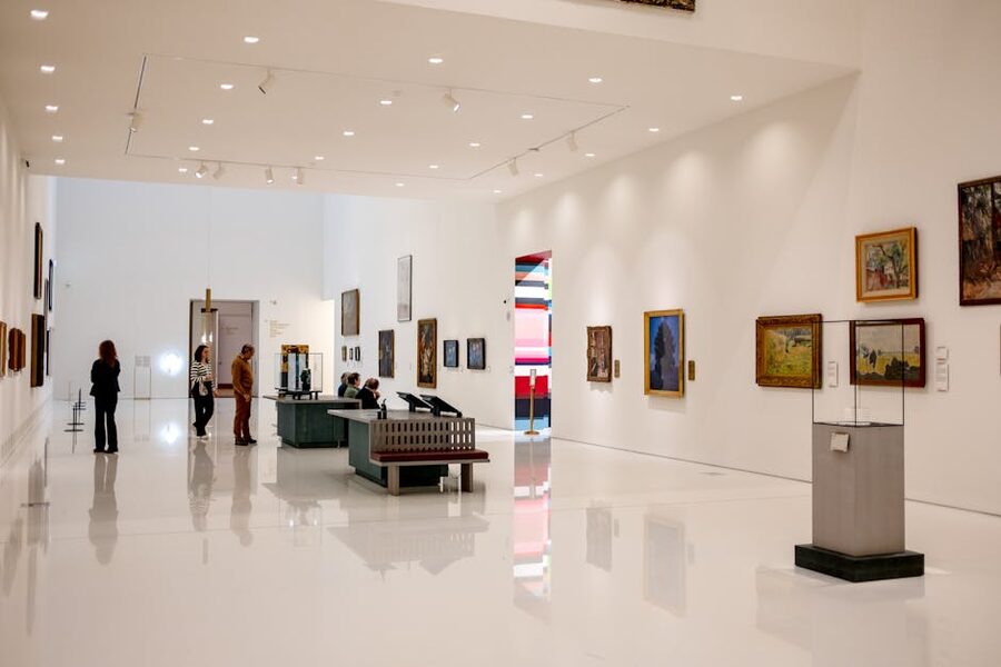 Visitors walking through an art museum gallery