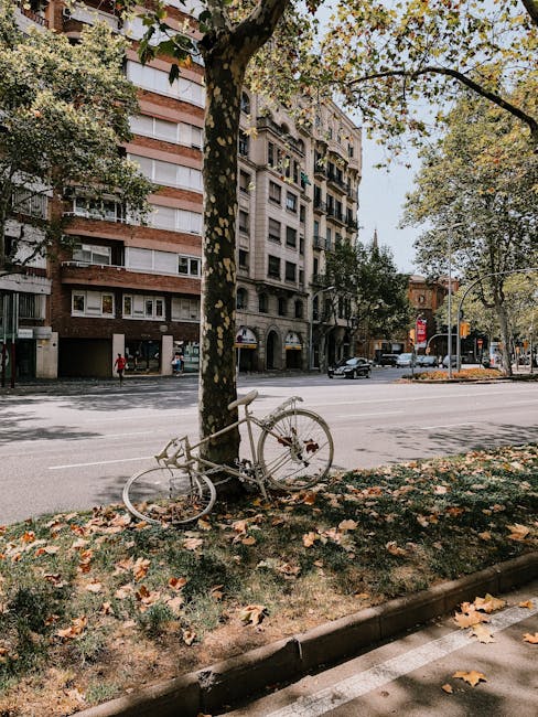 Bicycle parked against railings on a Barcelona street