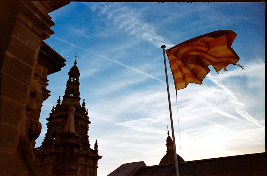 Catalan flag flying at a monastery with pilgrims