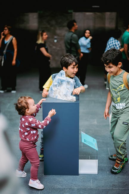 Children studying paintings on the wall of an art museum