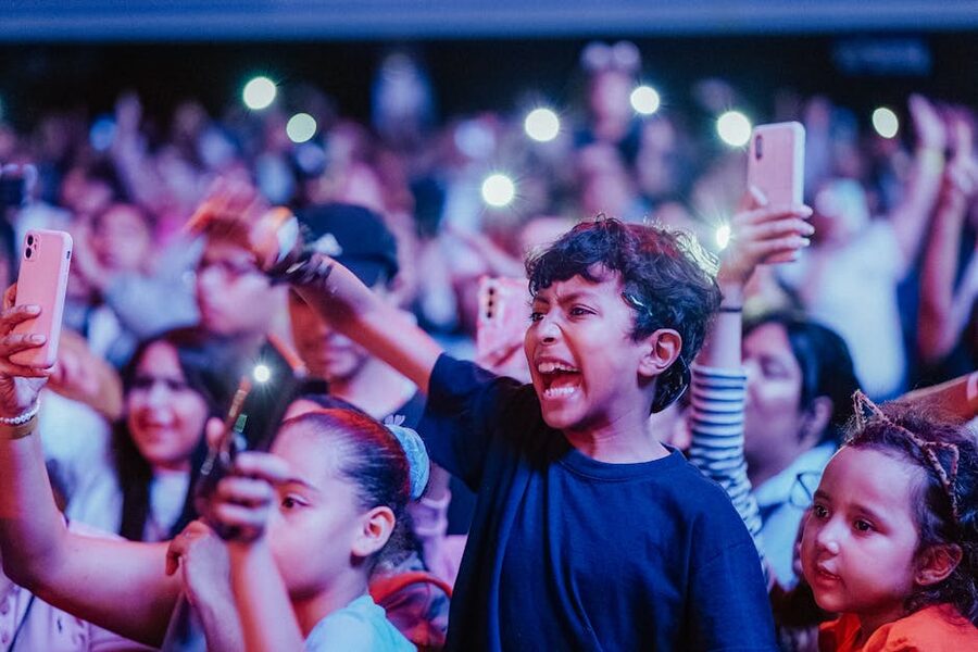 Children sitting in audience watching a live performance