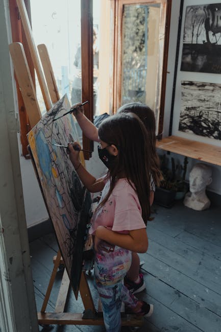 Children painting at easels in an art workshop