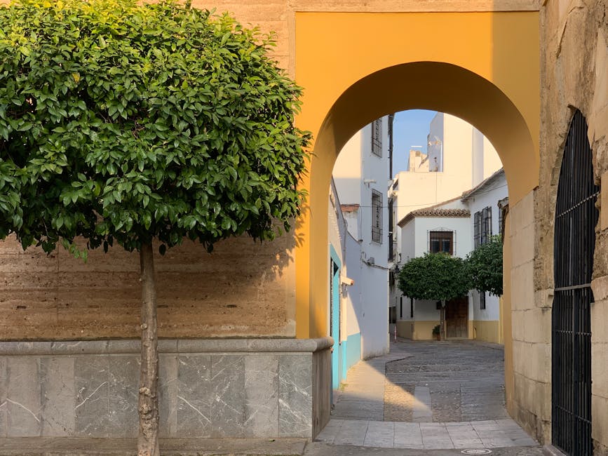 Andalusian village street through yellow arch