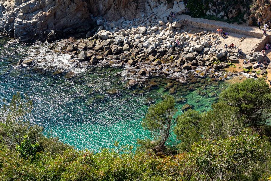 Hidden turquoise beach cove along the Costa Brava coastline