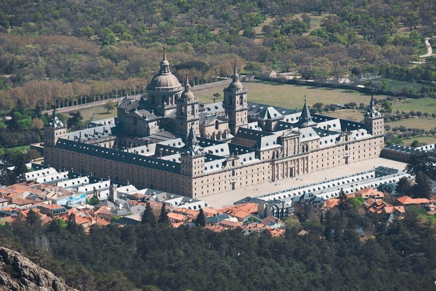 Aerial view of El Escorial surrounded by greenery