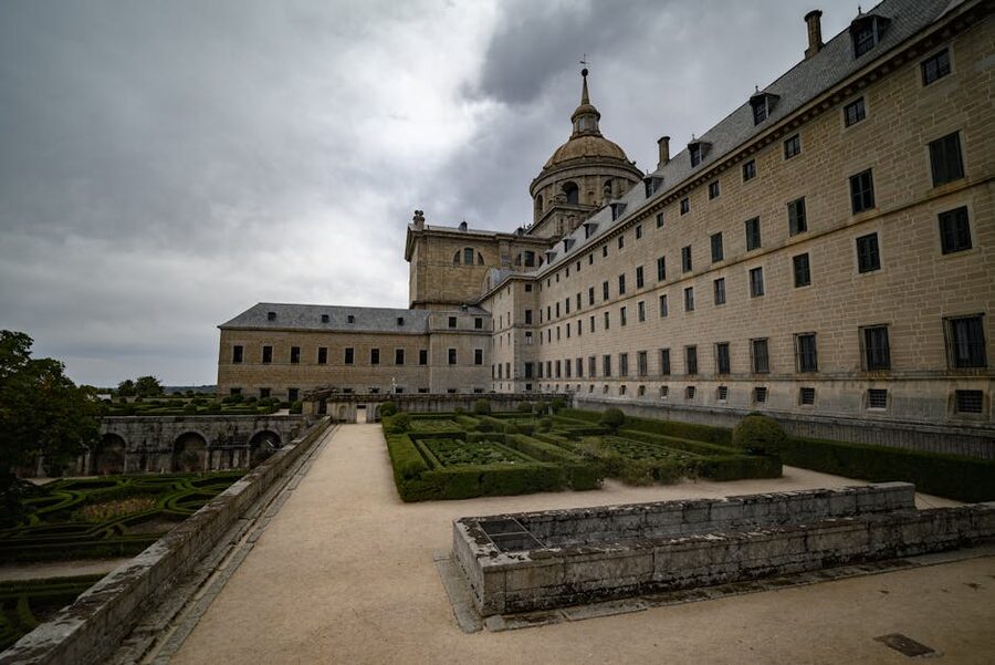 El Escorial monastery and gardens under dramatic sky