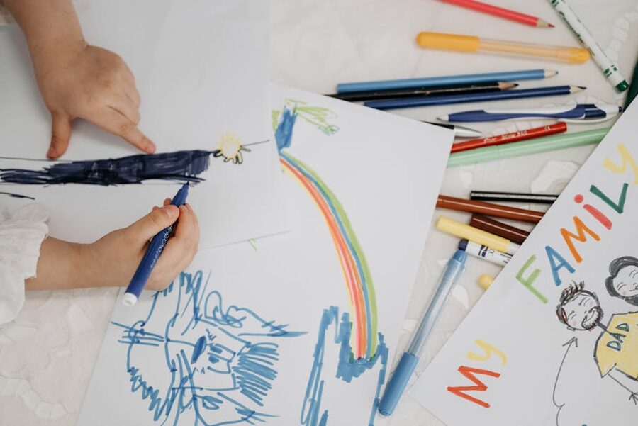 Family with children drawing and painting together