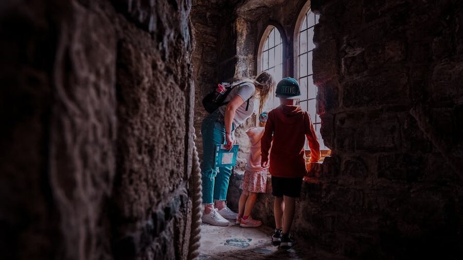 Family with children exploring inside a medieval castle