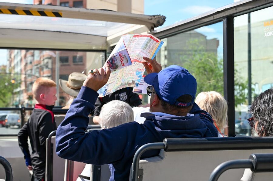 Family enjoying a ride on an open-top tourist sightseeing bus