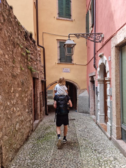 Family with children walking along a cobblestone street in an old town