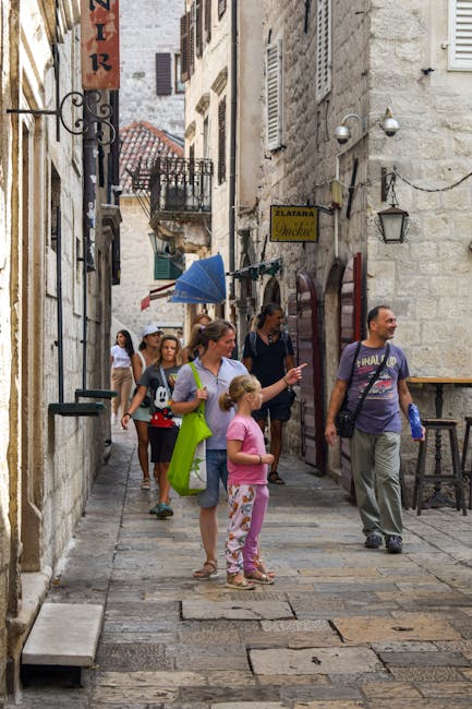 Family with children walking through a European old town street