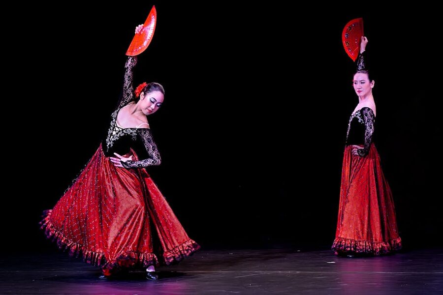 Flamenco dancers with red fans