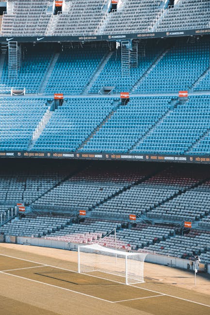 Rows of empty colourful seats in a football stadium