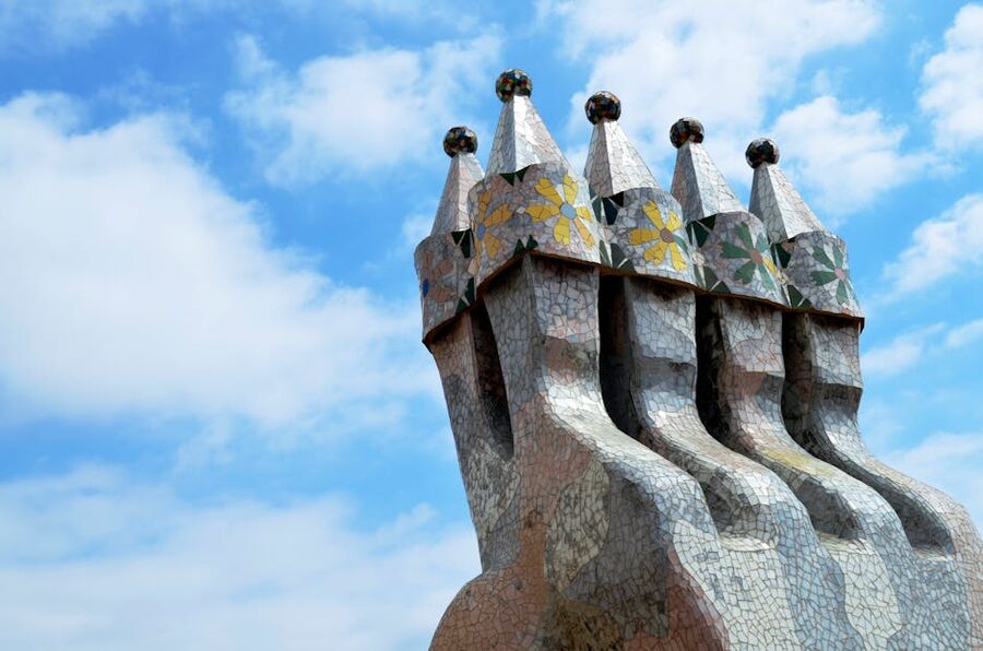 Colourful mosaic chimneys on a Gaudi rooftop