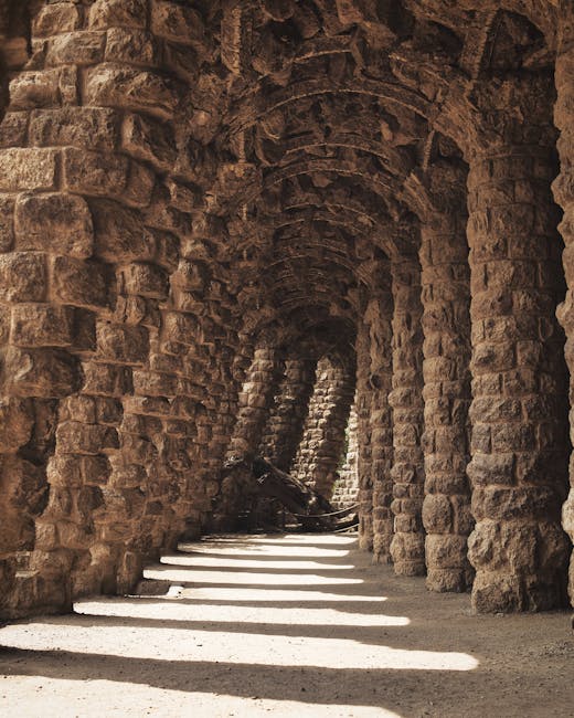 White parabolic arches inside a Gaudi building