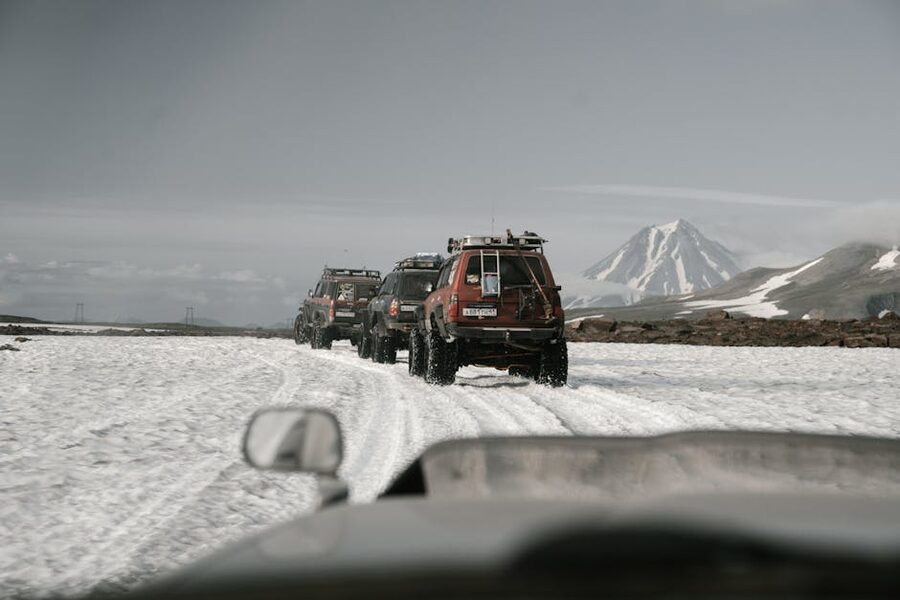 Jeeps offroad in snow mountain