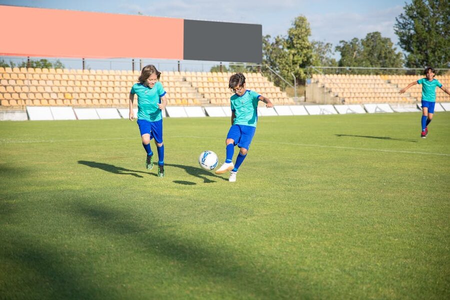Children playing football in sunny Spanish stadium
