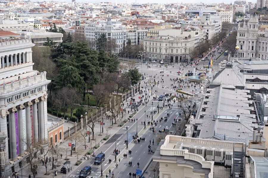 Paseo del Prado boulevard in Madrid with trees and buildings