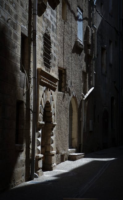 Dark medieval alleyway with stone walls