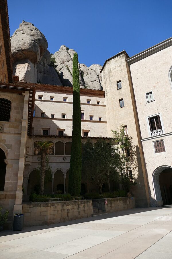 Gothic stone cloister arches inside Montserrat monastery