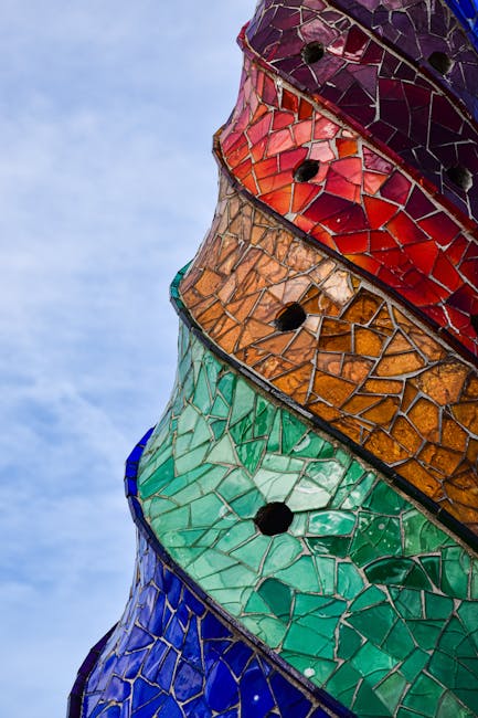 Colourful mosaic-covered pillar in Barcelona Modernisme style