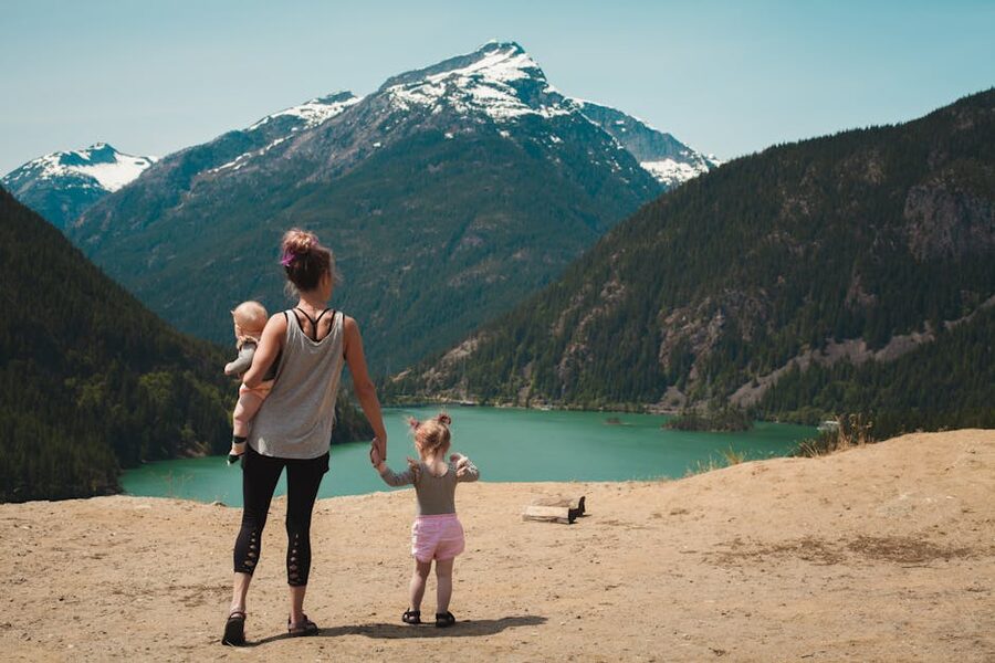 Family with children hiking along mountain trail