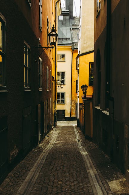 Narrow medieval alley with iron lamps