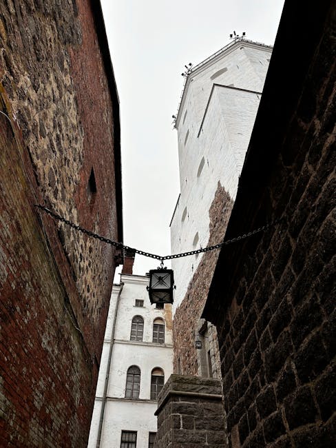 Narrow medieval street with old lanterns and stone walls
