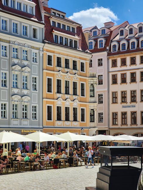People sitting at cafe tables in an old town square