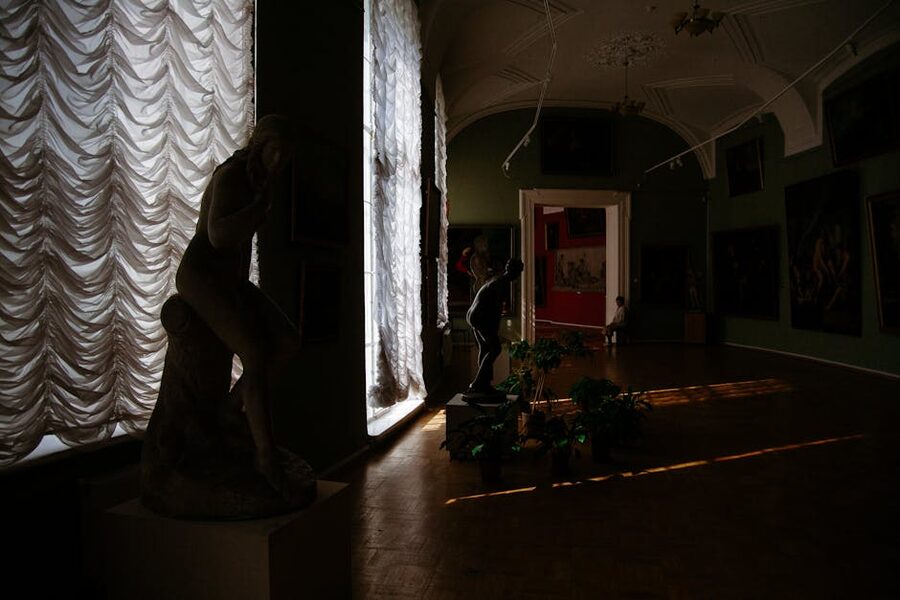 Dark atmospheric painting in dimly lit museum gallery
