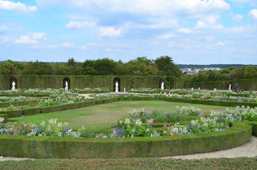 Formal palace garden with clipped hedges and a central fountain
