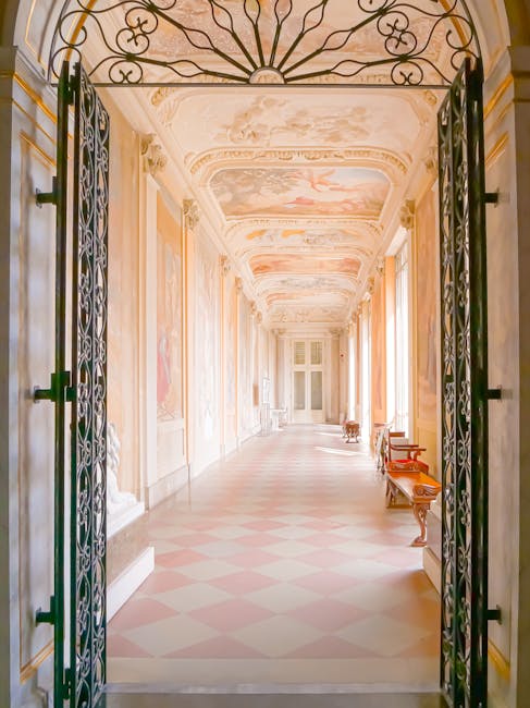 Ornate palace corridor with gold trim and mirror reflections