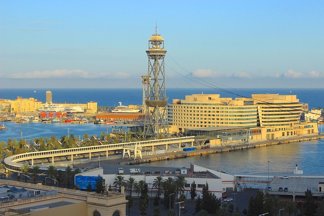 Boats moored in Port Vell harbour Barcelona with city behind