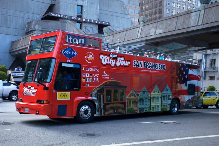Red open-top double decker sightseeing bus on a city street