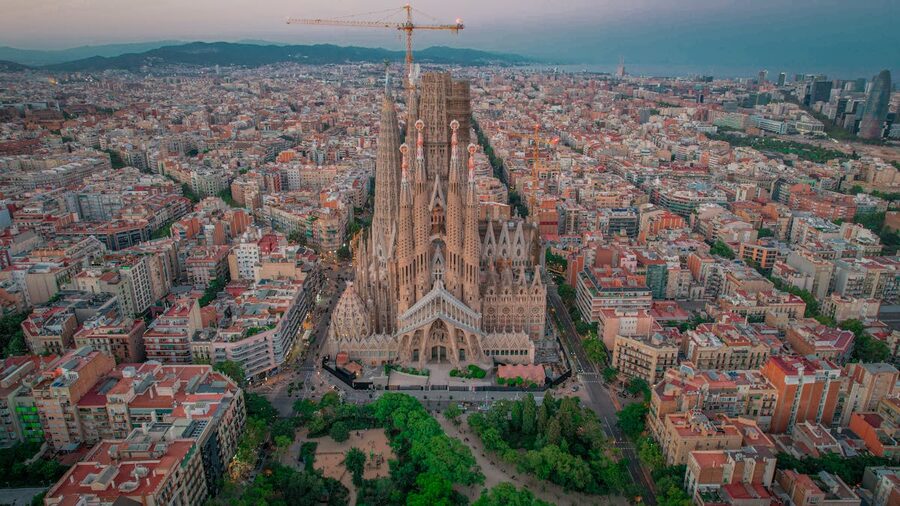 Aerial view of Sagrada Familia rising above Barcelona rooftops