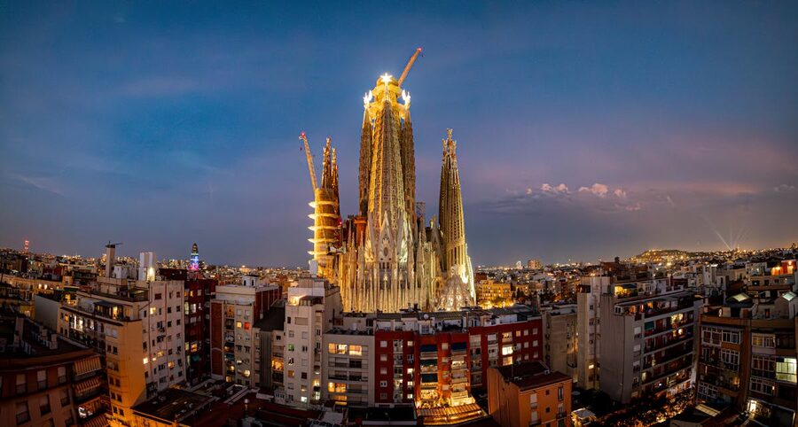 Sagrada Familia lit up at twilight showing its facade details