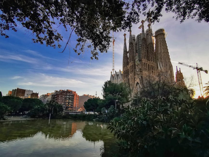 Sagrada Familia reflected in the pond at Placa de Gaudi park