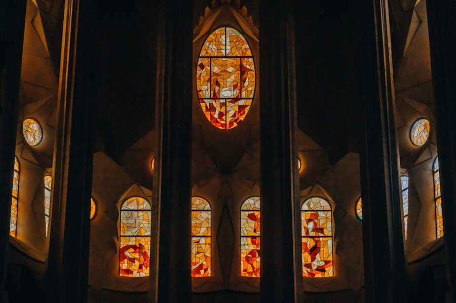 Colourful stained glass window inside Sagrada Familia casting light