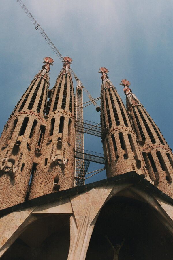Low angle view of Sagrada Familia towers reaching into blue sky