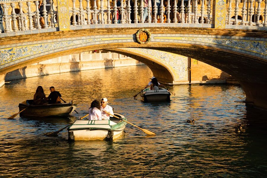 Rowboats on sunlit canal in Seville