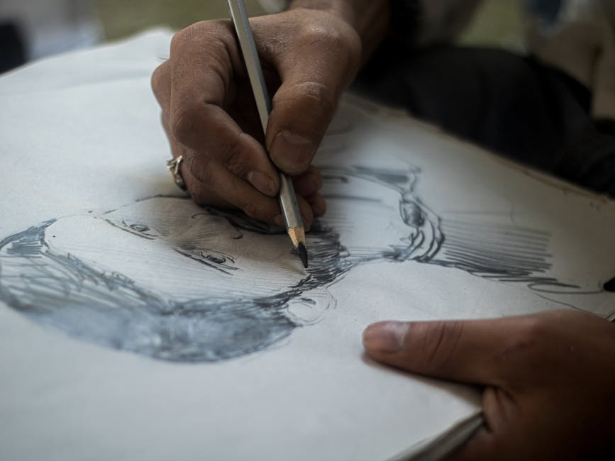 Artist hand sketching with pencil on paper